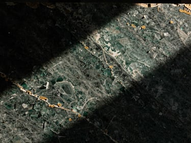 Rare emerald quartzite slab with crystalline structures, dramatic side light