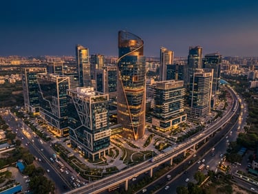 Aerial drone perspective of a modern commercial high-rise hub in Delhi NCR, clean leading lines, sharp architectural photography, golden hour light