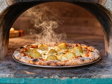 A freshly baked traditional Gozitan ftira pizza coming out of an old stone wood-fired oven, melting cheese and local potatoes, warm steam, editorial photography.
