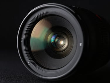 Close-up of a high-end camera lens, sharp reflections of a dark studio space, desaturated tones, anamorphic flare.