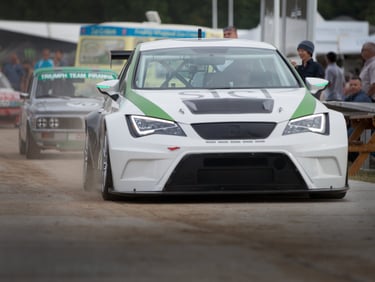 Cars getting ready to assemble before dring up the track at the Goodwood Festival of Speed 2015