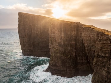 Faroe Islands photo tour in April – dramatic spring landscape with fresh green valleys and moody cliffs.