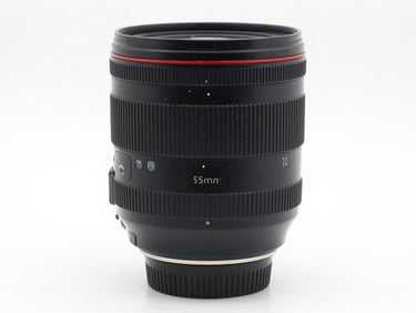 Sharp close-up of a professional camera zoom lens, clean white studio backdrop, bright high-key lighting, professional camera gear, 85mm lens