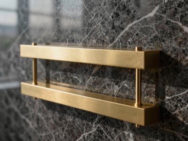 Wide panoramic close-up of bespoke champagne-gold fixtures against dark Italian marble, crisp morning light highlighting the material texture.