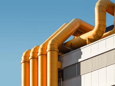 a large yellow pipework on a building