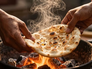 Close-up of hands tearing freshly baked flatbread, steam rising, warm glowing charcoal embers in the background, low-angle golden light, 35mm