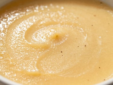 Macro texture shot of a golden, glistening custard surface with real vanilla bean flecks, warm afternoon Miami sunlight casting soft shadows, shallow depth of field, high-contrast editorial food photography.