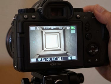 Low-key lighting of a high-end camera monitor displaying a crisp architectural frame on a professional film set.