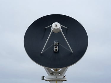 Modern satellite tracking station or marine sensor buoy in open ocean, clean corporate framing, 35mm