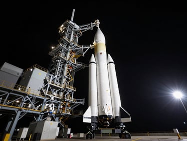 Wide shot of the SLS rocket on the launchpad at dusk, dramatic key light, high contrast, cinematic aerospace photography