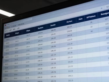 Precise overhead crop of a technical schematic on a screen showing structured database tables, cool high-contrast studio lighting
