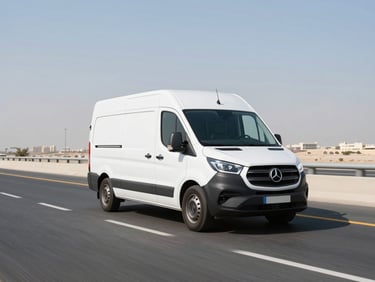 A modern delivery van driving smoothly down a clean Dubai highway during bright sunny day, high-contrast professional tones, 35mm