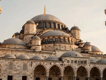 Warm editorial shot of historic stone architecture in Istanbul, soft morning light, elegant luxury aesthetic, 35mm lens