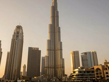 Golden-hour view of modern architectural marvels in Dubai, soft natural light, luxury travel aesthetic, 35mm lens