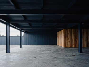 Minimalist modern warehouse interior with clean steel beams and raw concrete floors, moody lighting, high contrast