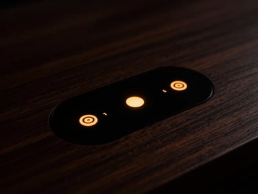 Close-up of a touch-sensitive control interface embedded under a dark wood surface, glowing warm amber indicator, low-key lighting.