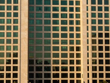 Clean architectural detail of prime commercial land in a modern business district in Karachi, warm evening light, 35mm