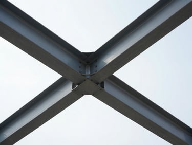 Low-angle architectural perspective of clean steel beams framing a bright sky, high-contrast, bright daylight