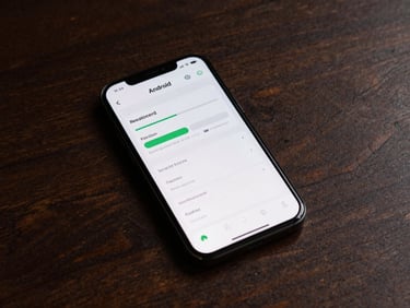 Android phone on a dark wooden desk, screen showing a minimal reading-progress tracker app, precise studio strobe from above, interface type sharp and legible, surrounding desk deliberately empty