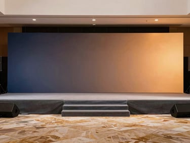 Premium corporate summit stage backdrop, modern sleek design, subtle branding, warm professional lighting, wide angle
