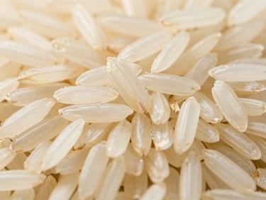 Close-up of long-grain Basmati rice, bright natural daylight, rich organic tones, high-detail macro, 35mm