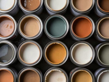 Overhead catalog shot of paint can lids arranged in a grid on dark surface, studio strobe lighting revealing metallic rim detail and label texture, color swatches implied by varied finishes