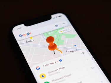 Close-up of a smartphone screen displaying Google Maps search results for a local business, with a bright orange pin and a map, moody professional tone, high contrast.