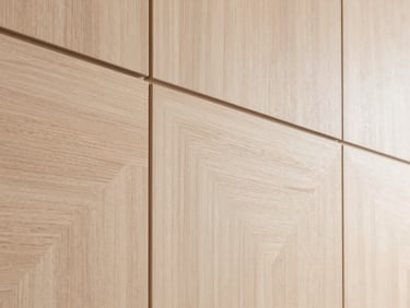 Clean architectural shot of custom wooden wall paneling in light ash wood, geometric lines, modern interior.
