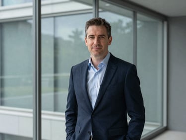 Professional portrait of David Thorne, male strategic advisor, modern clean glass partition background, cool daylight, 35mm