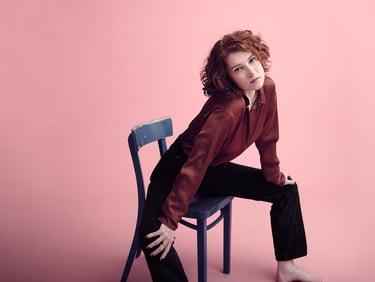 Woman stretching in a blue chair.