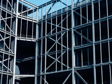 Abstract architectural lines of a modern steel structure, deep blue shadows, high-contrast cool daylight, minimalist composition, 35mm