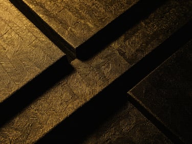 Moody editorial macro photography of structured woven fabric with golden threads, sharp geometric architectural angles, dramatic studio lighting, 35mm