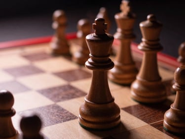 High-contrast shot of a wooden chess king on a board, dramatic shadows, soft warm lighting