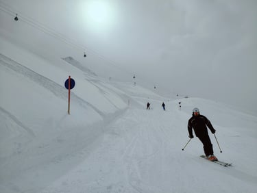 a person skiing down a snowy slope