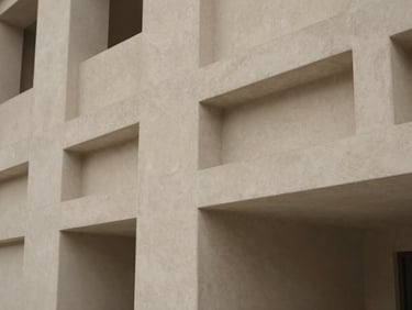 Abstract architectural detail of an understated modernist structure in Dubai, clean concrete lines, soft shadows.