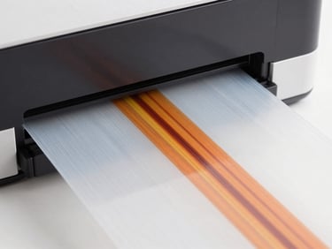 A digital printer head outputting vibrant high-resolution graphics onto a transparent transfer film