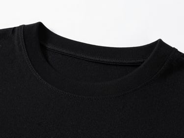 Close-up of a premium black cotton t-shirt collar showing tight fabric weave and clean stitching, minimalist studio setup.