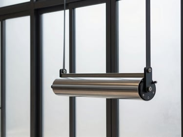 Close-up of a heavy-duty roller mechanism on a large-span sliding glass door, sharp natural light, deep charcoal and metallic silver tones, high-contrast, minimalist composition