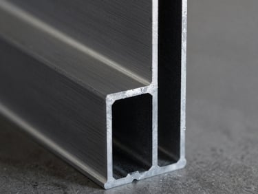 Macro shot of a clean miter joint on a raw aluminum profile in a workshop, sharp clean workshop lighting, deep charcoal and metallic silver tones, high-contrast