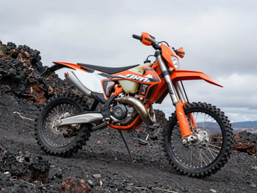 KTM EXC 250 dirt bike parked on steep volcanic rock trail, overcast light revealing orange frame and knobby tyre detail, shot from low 3/4 angle showing seat height and suspension travel