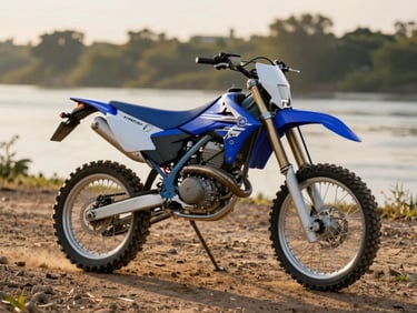 Yamaha WR155R trail bike parked on packed dirt near river bank, golden-hour side light showing blue plastics and tyre tread, shot from rider's perspective showing manageable seat height relative to surroundings