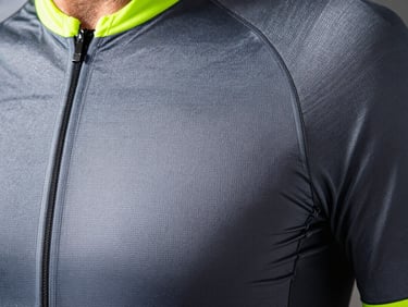 Macro detail of high-performance cycling jersey fabric weave, neon accents, high contrast slate tones