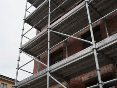 Low angle shot of heavy steel scaffolding erected against a brick facade in Stockholm under overcast daylight, clean industrial joints
