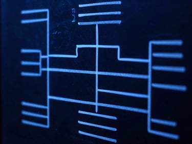 Close-up of a complex system architecture diagram hand-drawn on a glass whiteboard, glowing sharp electric-indigo marker lines, deep slate background, macro lens, high contrast