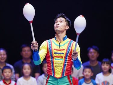A dynamic close-up of a professional circus performer in a vibrant, immaculate costume juggling under bright stage lights, smiling children watching in the blurred background