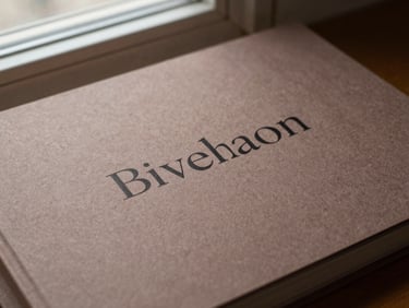 Macro shot of a minimalist brand identity guide book, heavy textured paper, elegant serif typography, soft natural window light, warm mocha shadows