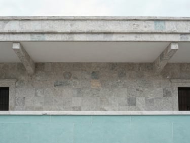 Minimalist architectural detail of a restored colonial home in Mérida, high ceilings, stone walls, soft natural light, clean lines