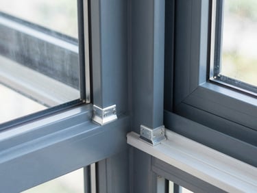 Close-up of clean aluminum joints and frame finishes on a modern window structure, architectural photography, sharp focus