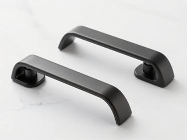 Close-up of sleek modern matte black door handles resting on a pristine white marble surface, sharp studio lighting, editorial style