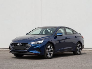 Three-quarter front view of a clean 2022 Hyundai Elantra in deep blue on a bright outdoor lot under even daylight, neutral asphalt background, no people